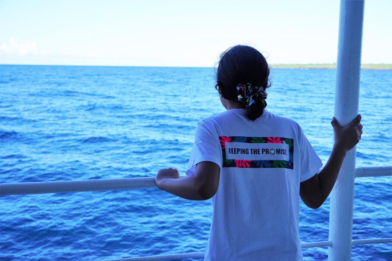 a girl on the boat wearing the keeping the promise tshirt