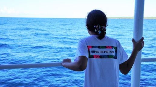 a girl on the boat wearing the keeping the promise tshirt